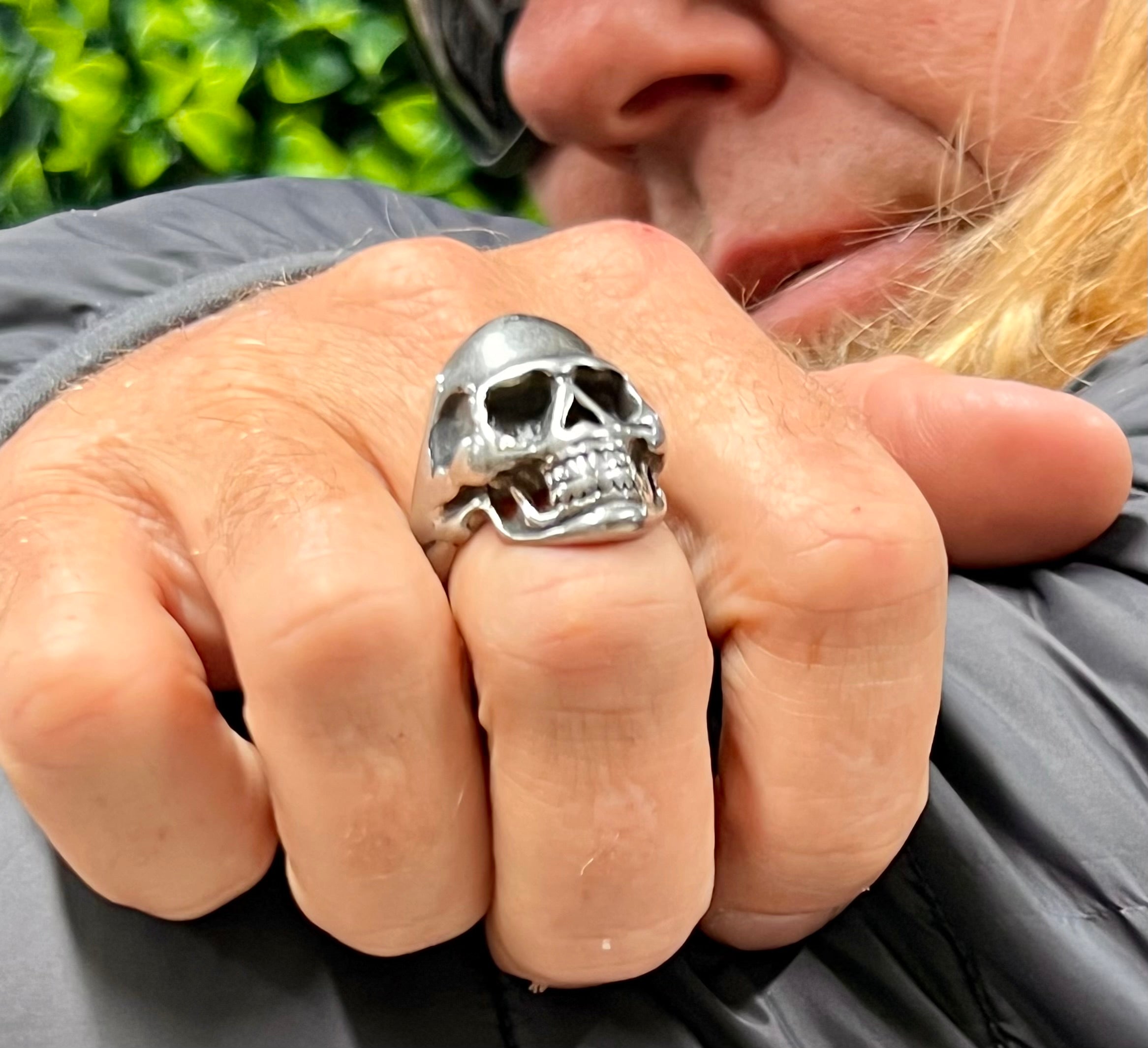 Model wearing stainless steel skull ring, bold masculine statement jewelry