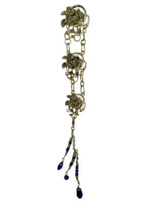gold rose chain hair accessory with blue crystal drop strands front view