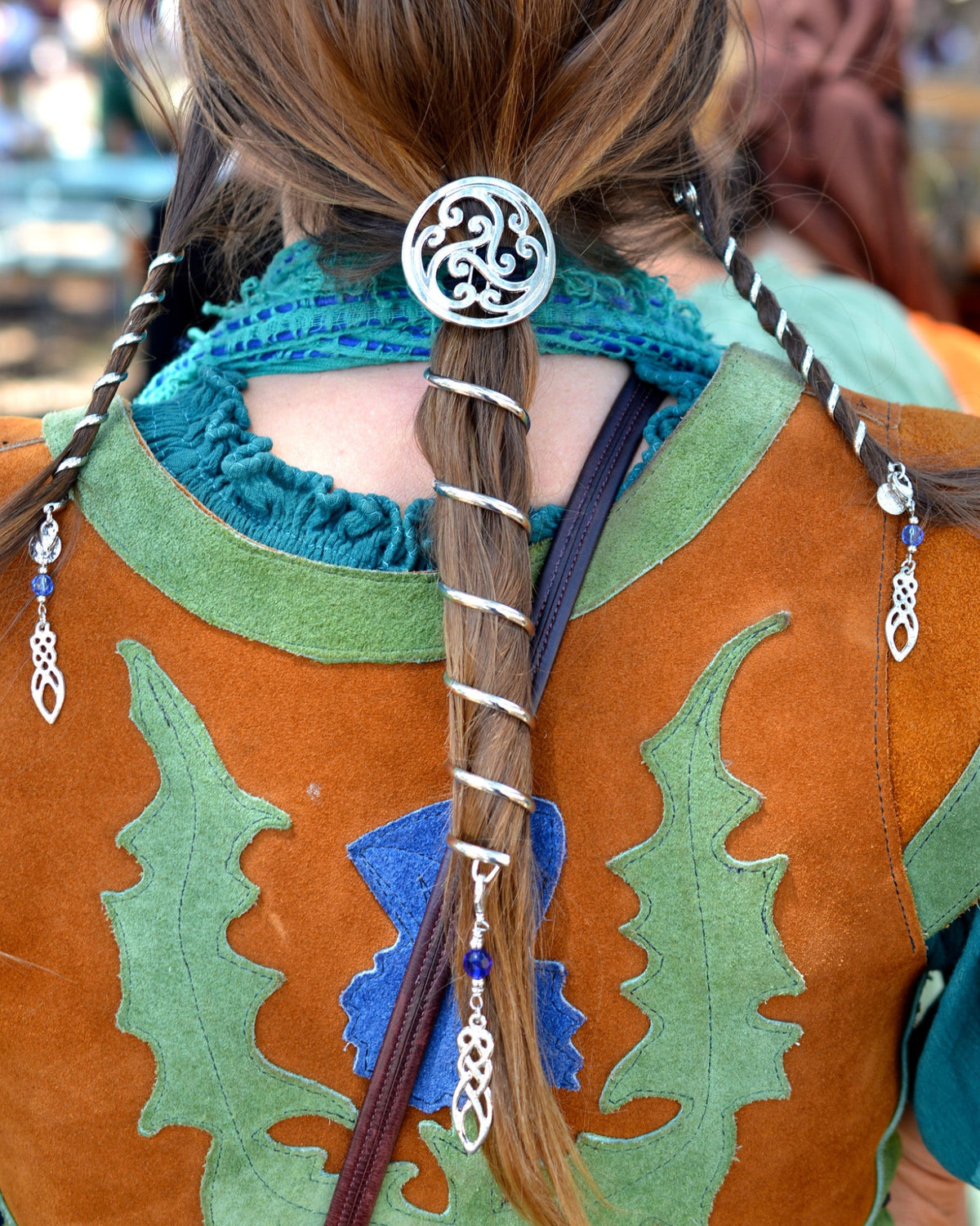 Celtic Power ponytail holder complete set with 6-inch spiral ponytail wrap and matching 4-inch Hair Twisters, featuring a Celtic knot design and blue crystal accents, worn by model from the back