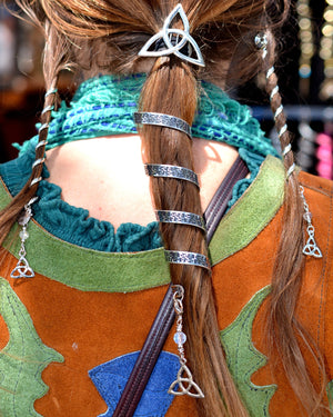 Stainless steel Celtic knot complete hair accessory set with 6-inch spiral ponytail holder and matching 4-inch Hair Twisters, featuring Trinity knot designs and crystal dangle charms, worn by model from the back.