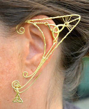 gold elf ear cuff worn on ear trinity knot wire wrap non piercing ear jewelry side view