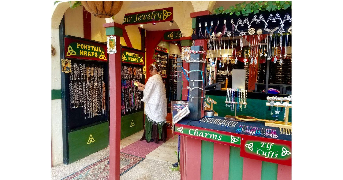 Interior of Medieval Metal shop at the Arizona Renaissance Festival with hanging hair accessories and festival displays