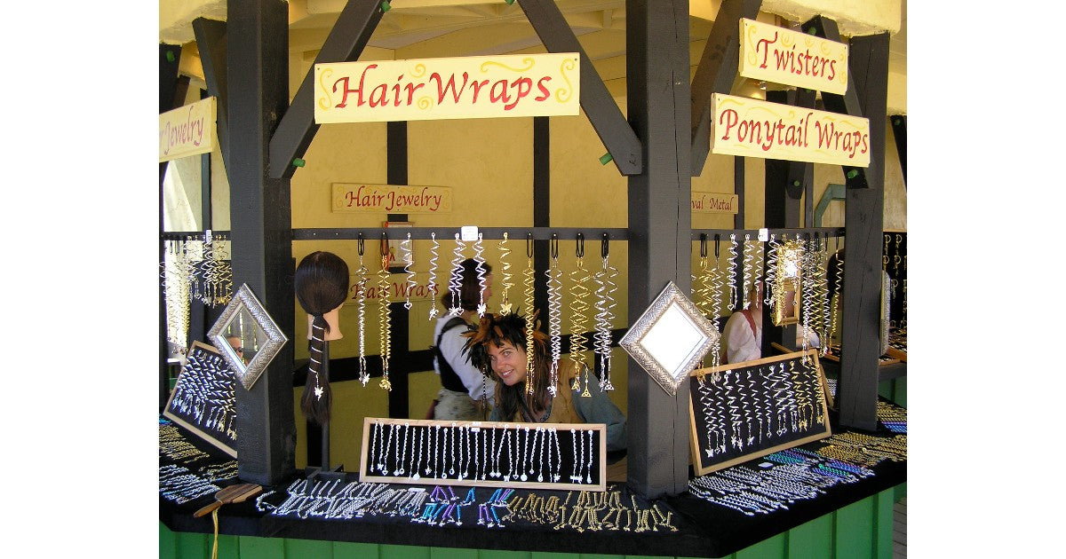 Medieval Metal booth display featuring Hair Wraps, Ponytail Wraps, and Renaissance hair accessories at Bristol Renaissance Faire.