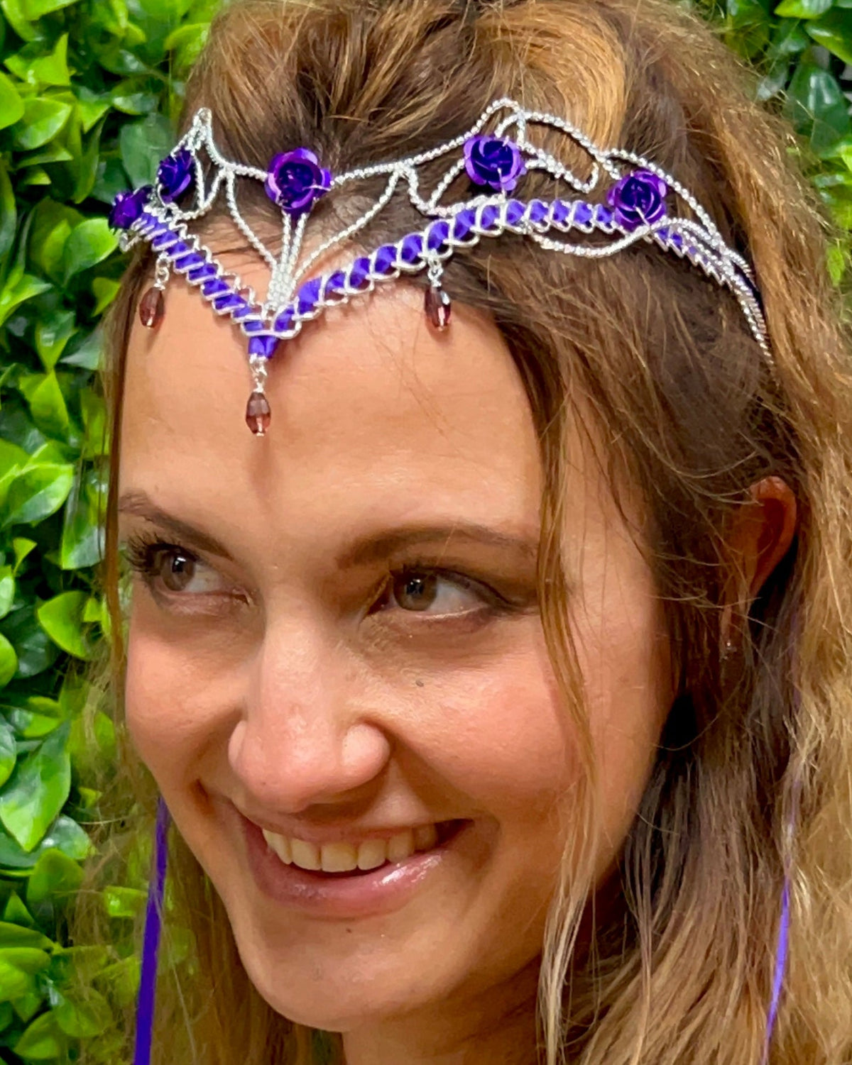 Model wearing a silver Fairy Princess Crown ribbon tiara with purple roses and crystal gemstone accents, fantasy crown for Renaissance Faire and cosplay.