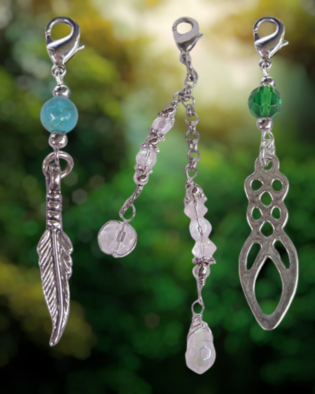 decorative silver hair charms with beads and crystal details for hair twisters ponytail wraps and hair hooks hanging against green background
