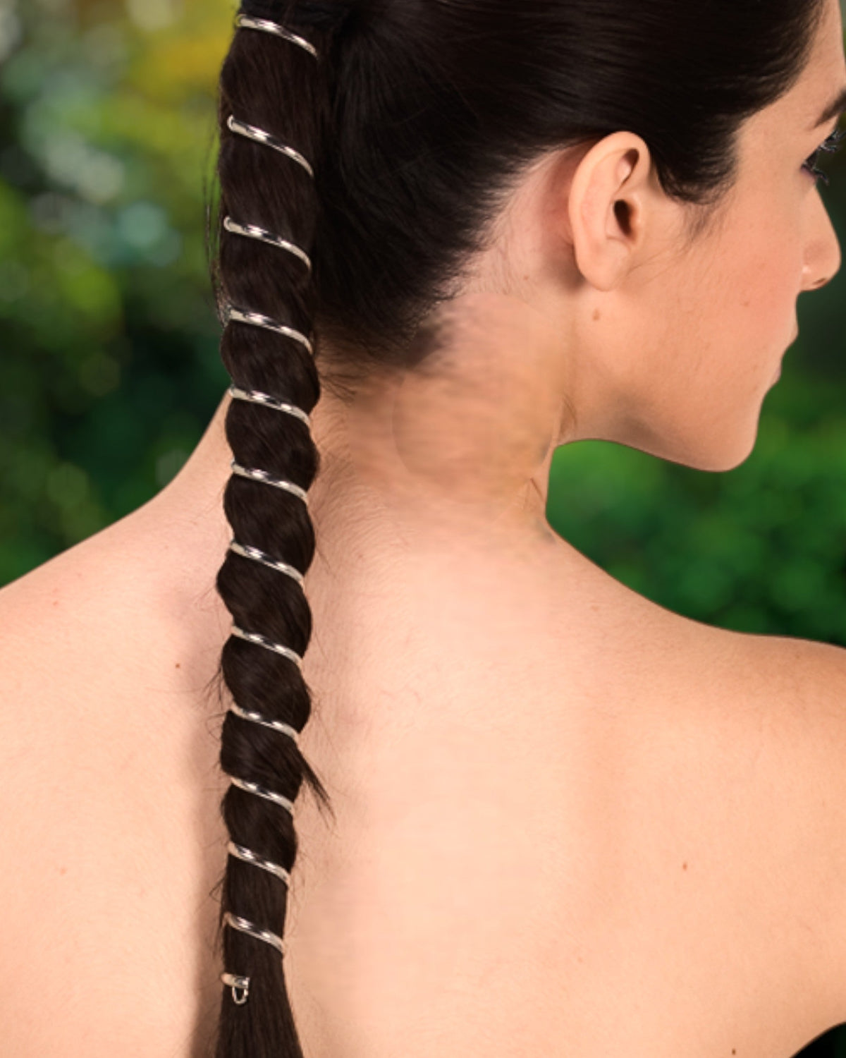 Model wearing 12-inch silver Metal Ponytail Wrap in long dark ponytail