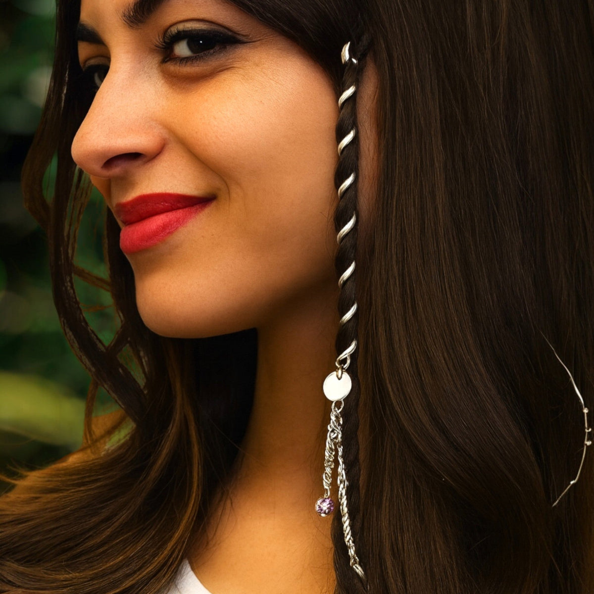 Model wearing 4 inch silver Hair Twisters spiral hair accessories with dangling bead charms in long dark hair