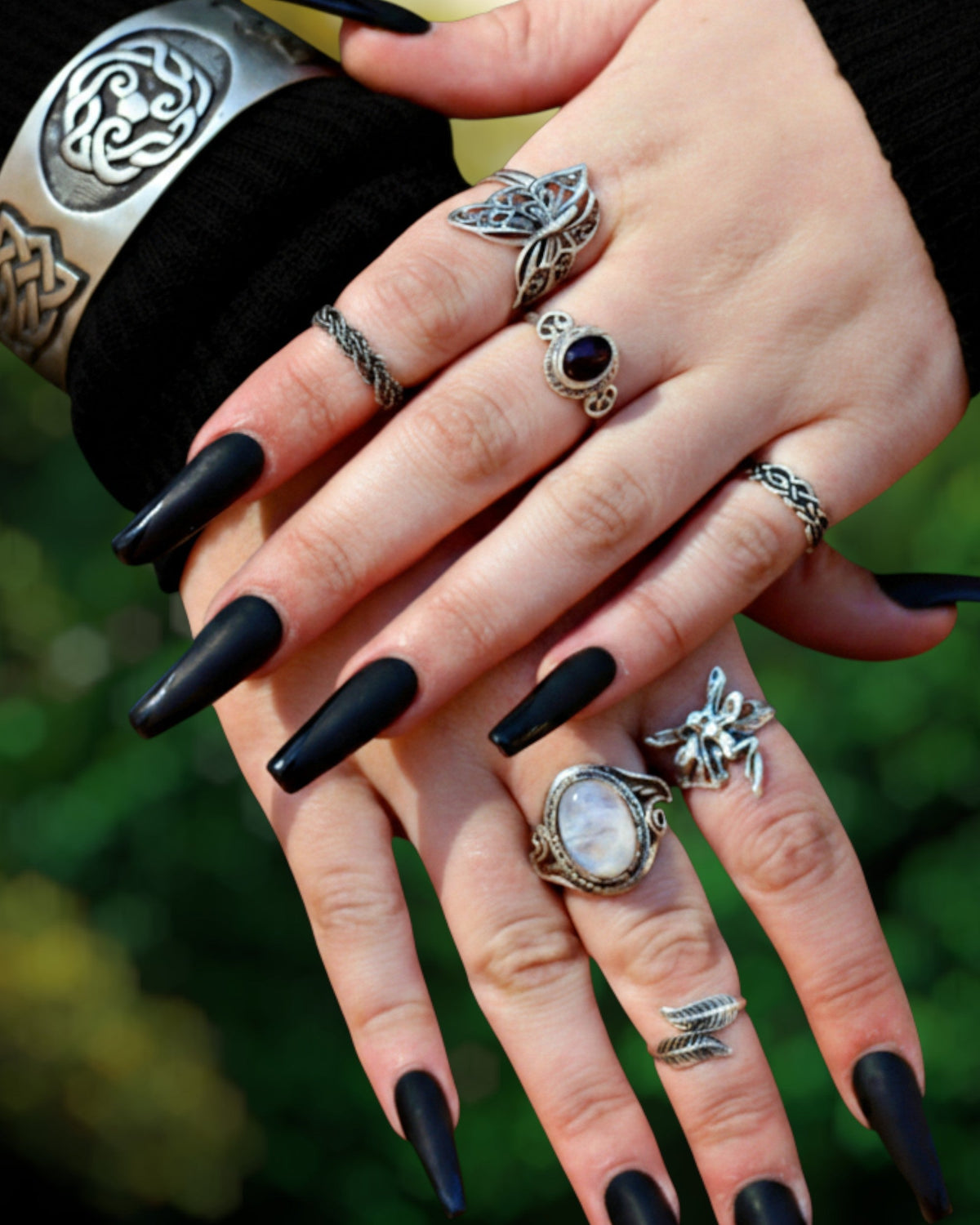 Model wearing Celtic, Gothic and Renaissance-inspired fantasy rings and silver jewelry on both hands