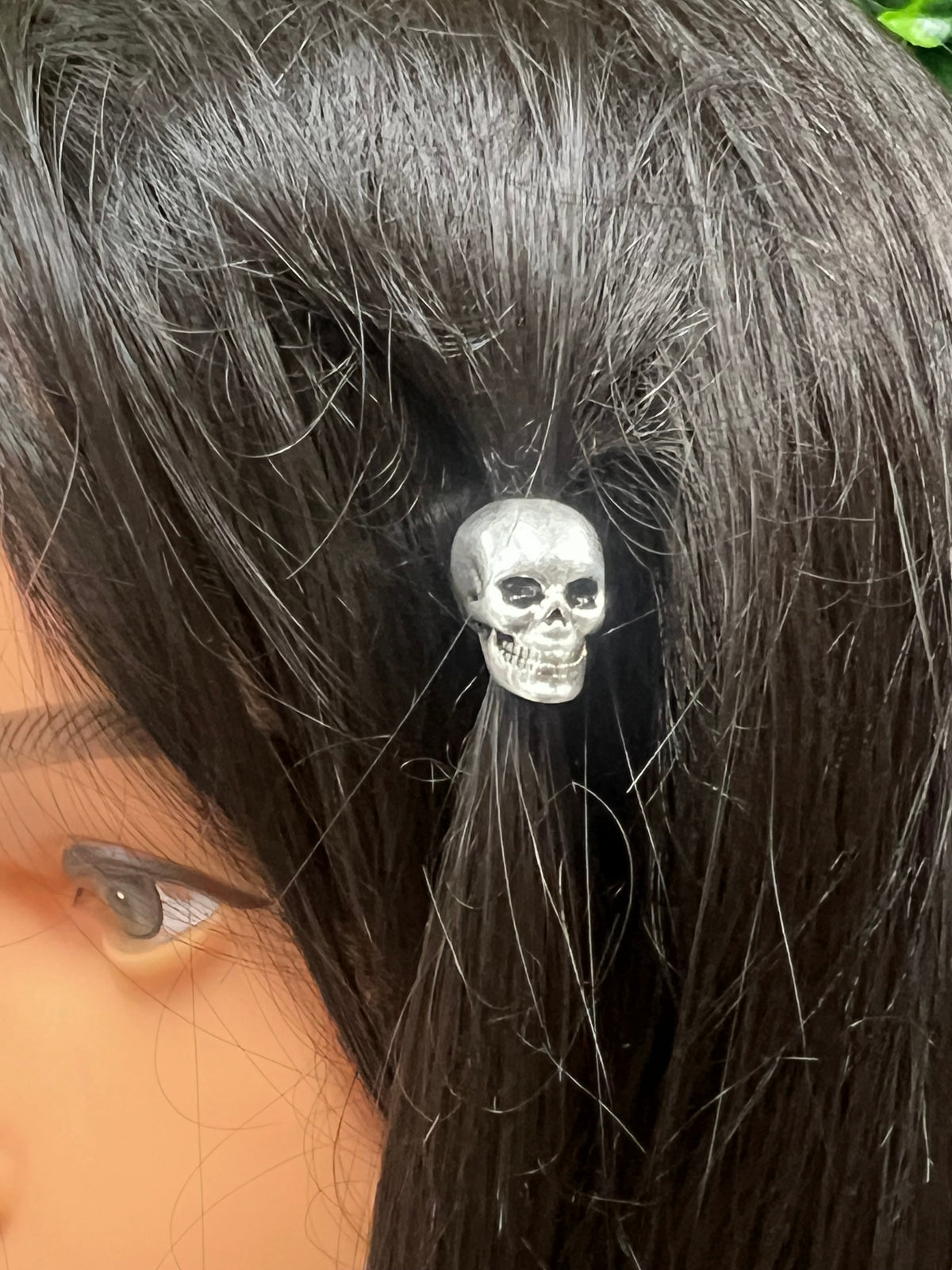 Silver skull hair bead worn in braided hair with gothic style