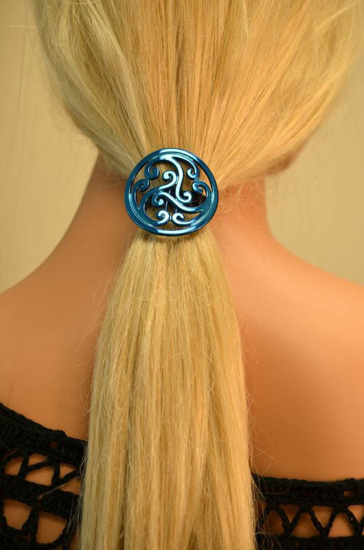 Model wearing a Blue Celtic Hair Hook ponytail holder securing a low ponytail with an intricate Celtic swirl design.