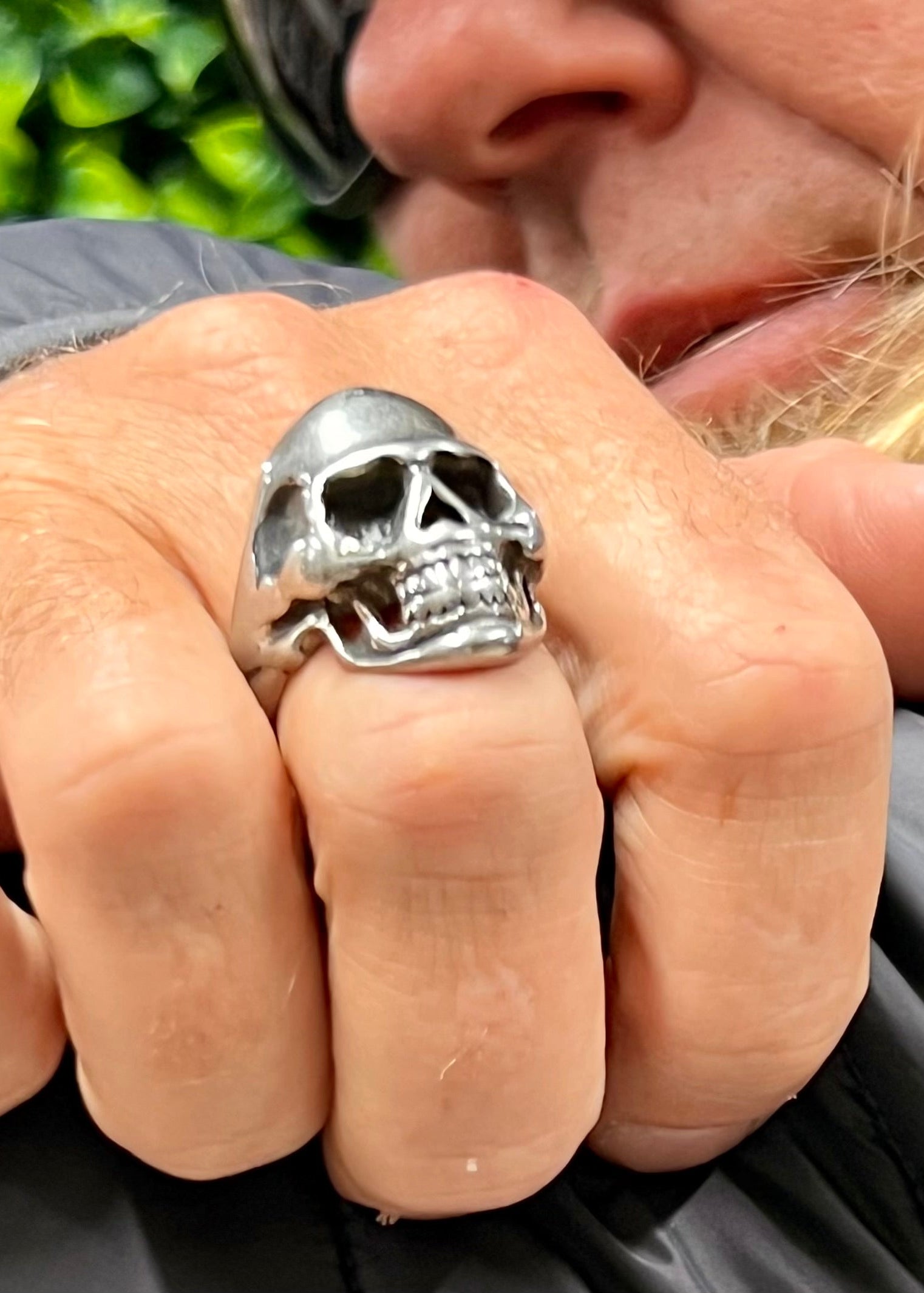 Model wearing stainless steel skull ring, bold masculine statement jewelry