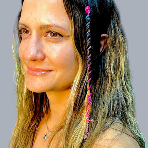 6 inch pink hair twister in long wavy blonde hair, metal spiral hair accessory styled in braid with dangling charm, side profile