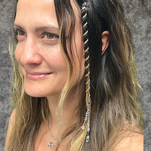 6 inch mini silver hair twister in long wavy blonde hair, spiral metal hair accessory with charm, styled in braid, side view