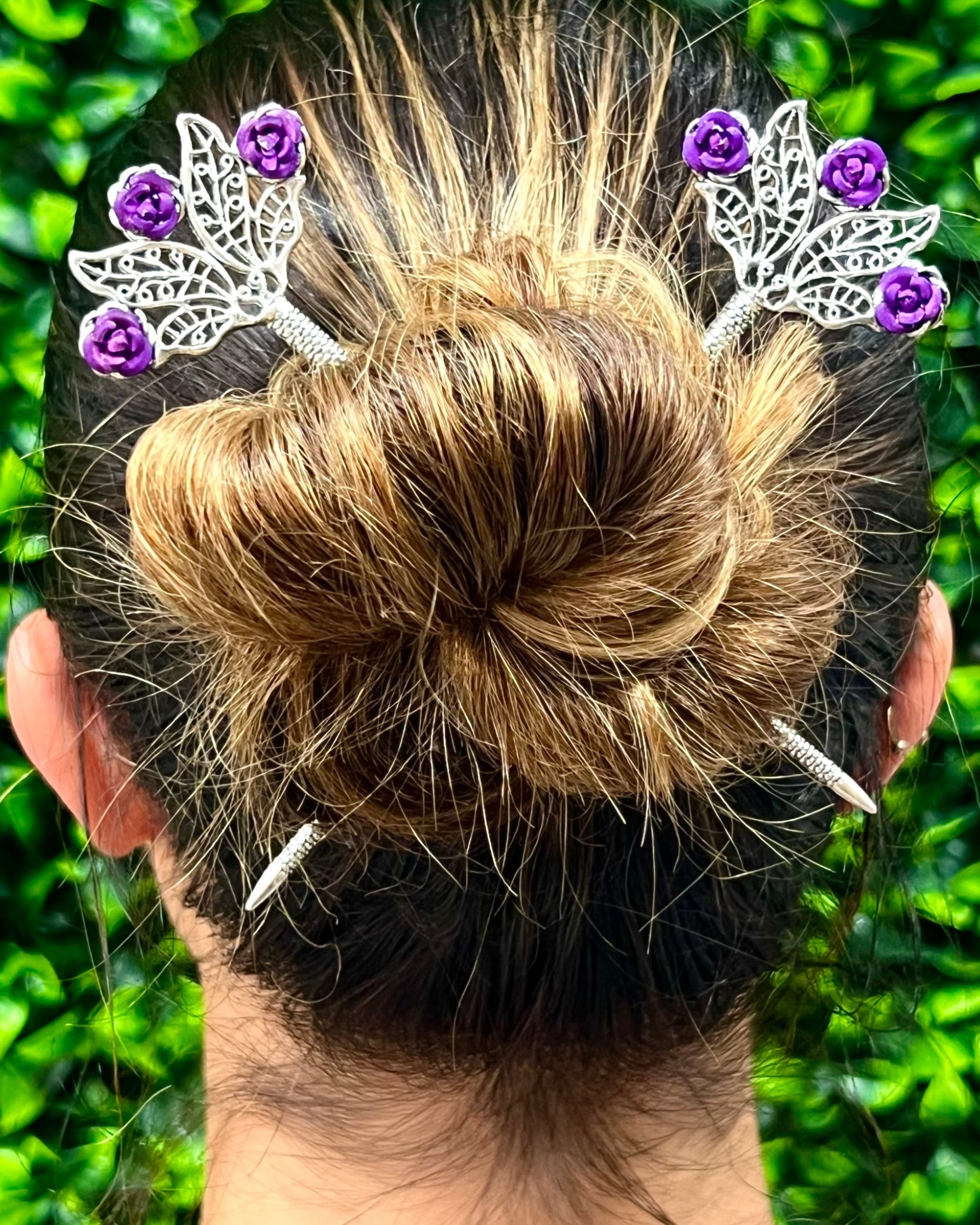 Model wearing Floral Fan Hair Sticks – Delicate flower hair accessories styled in a bun with silver floral fan hair sticks featuring purple rose accents.