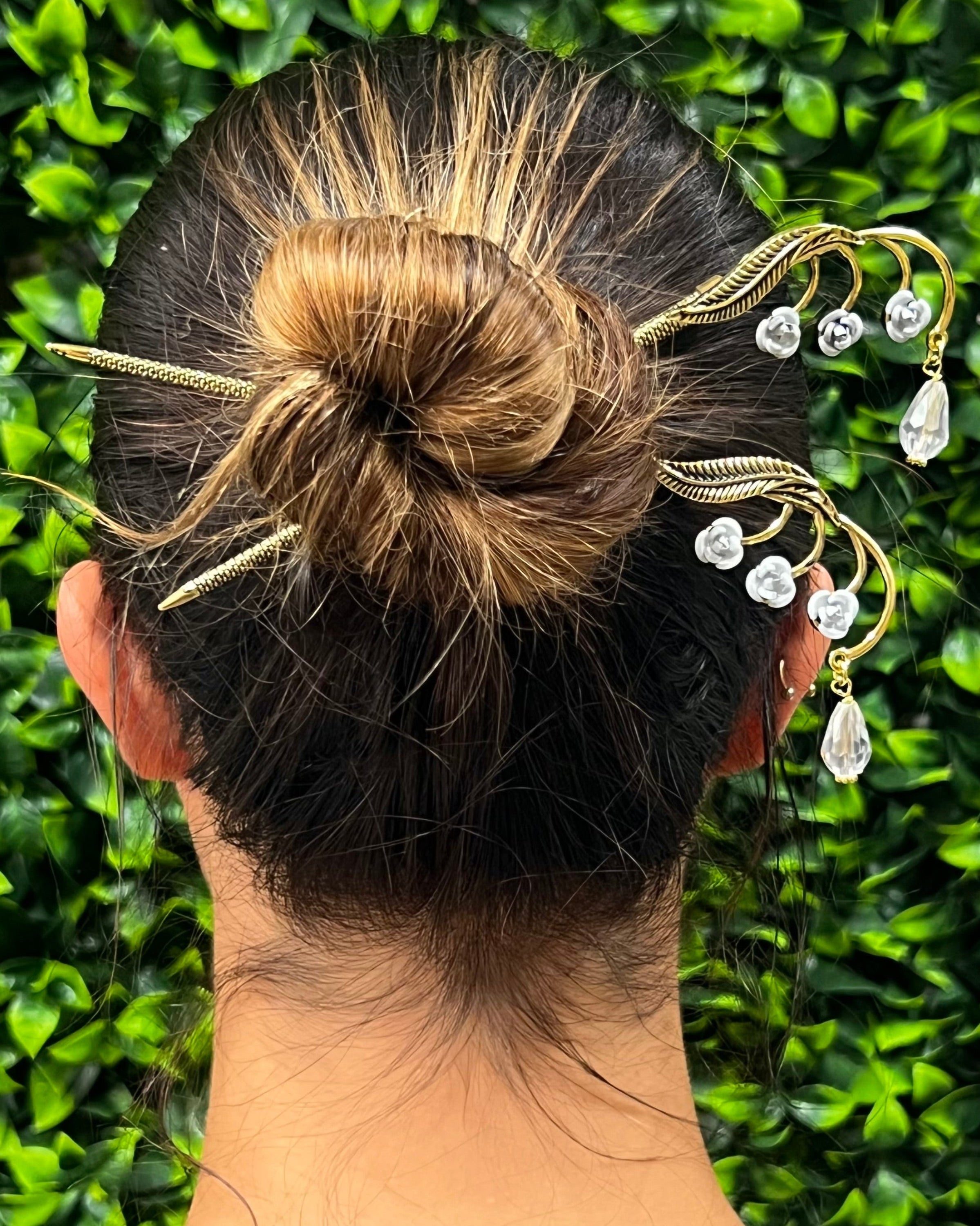Leafy Flower Gems Hair Sticks worn in a bun hairstyle with clear crystal accents, rear view.