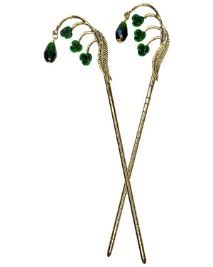 Gold Feather Hair Sticks featuring a feather design with green crystal drops, pair shown front view on a white background.