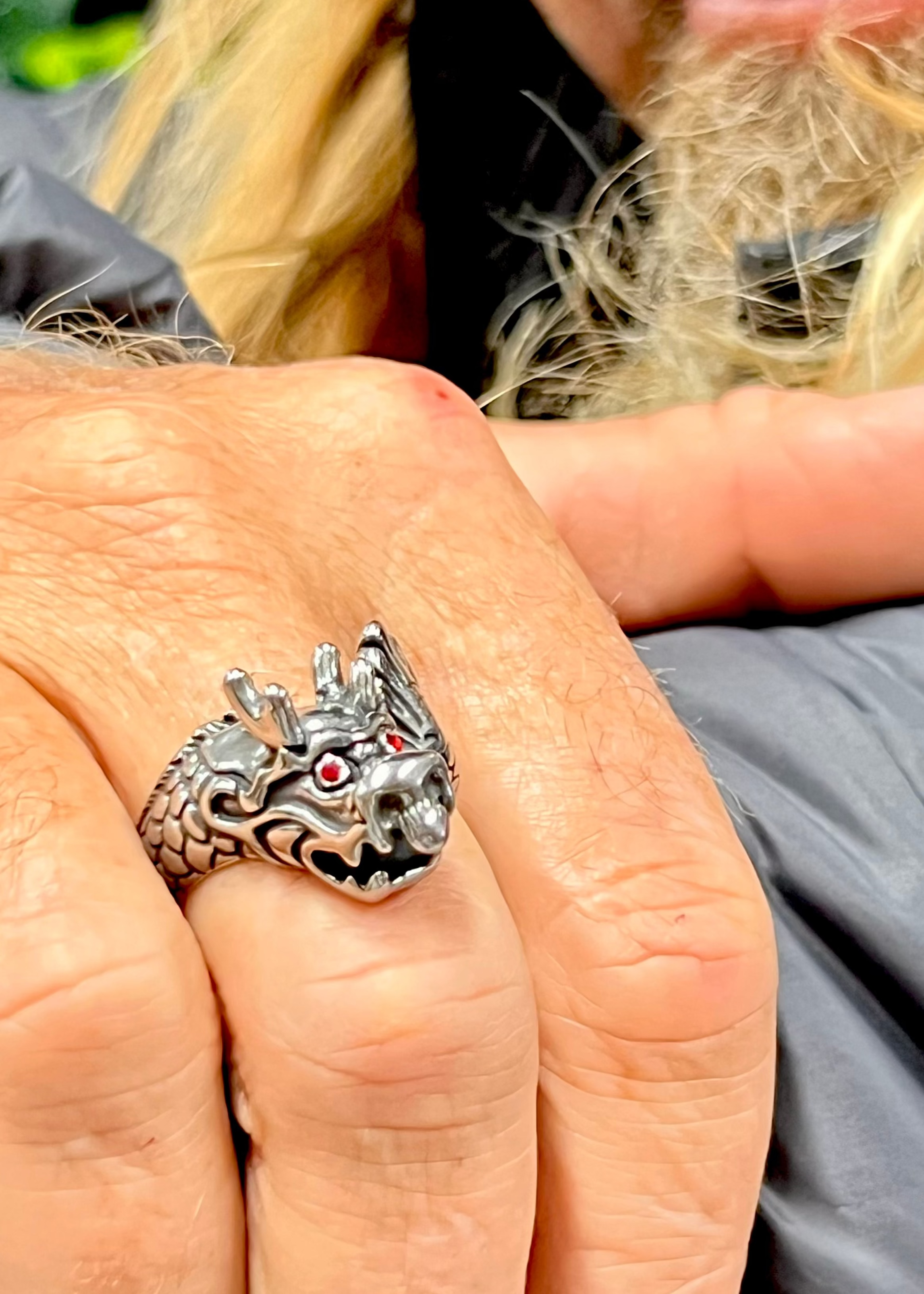 stainless steel dragon ring with red eyes front view worn on model