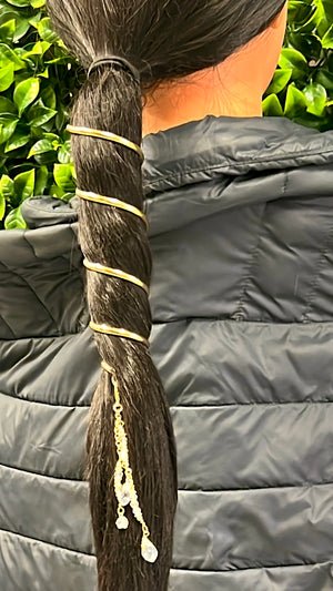 Model wearing gold 6-inch spiral ponytail wrap hair accessory