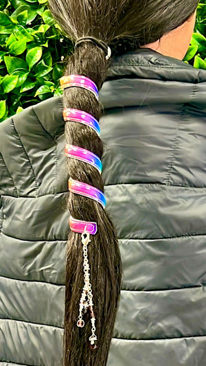 Model wearing 6 inch unicorn rainbow holographic faux leather spiral ponytail wrap hair twister, back view outdoors