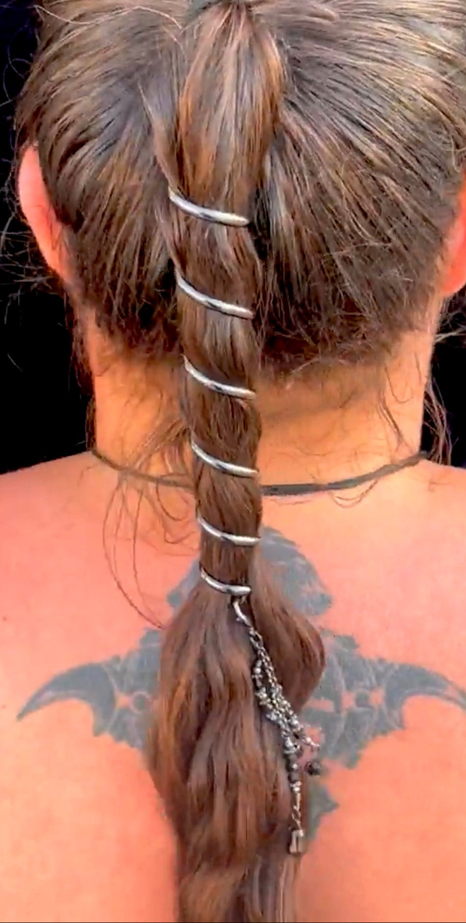 Model wearing gunmetal black 6-inch spiral ponytail wrap hair accessory