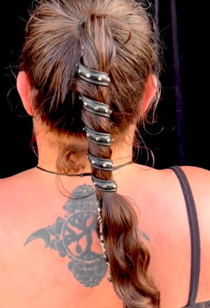 Black leather spiral hair twister ponytail wrap with silver rivets, back view worn in hair