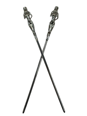 silver sculpted figure hair sticks decorative metal hair pins crossed front view