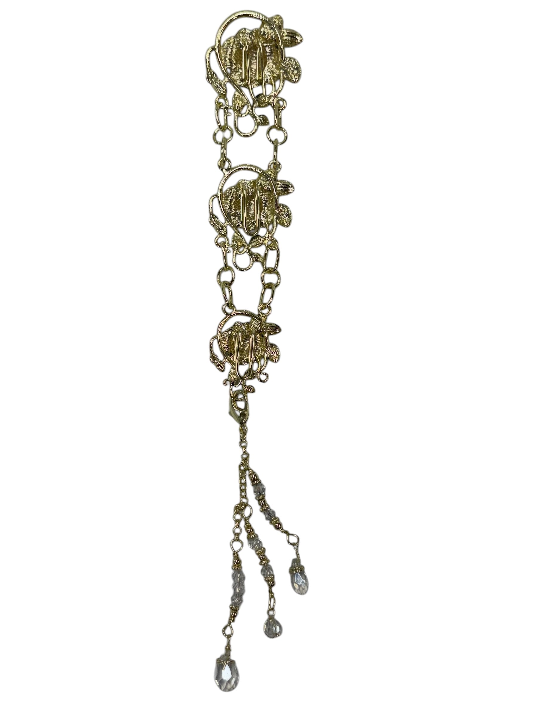 gold chain hair accessory with decorative charms and crystal drop strands front view