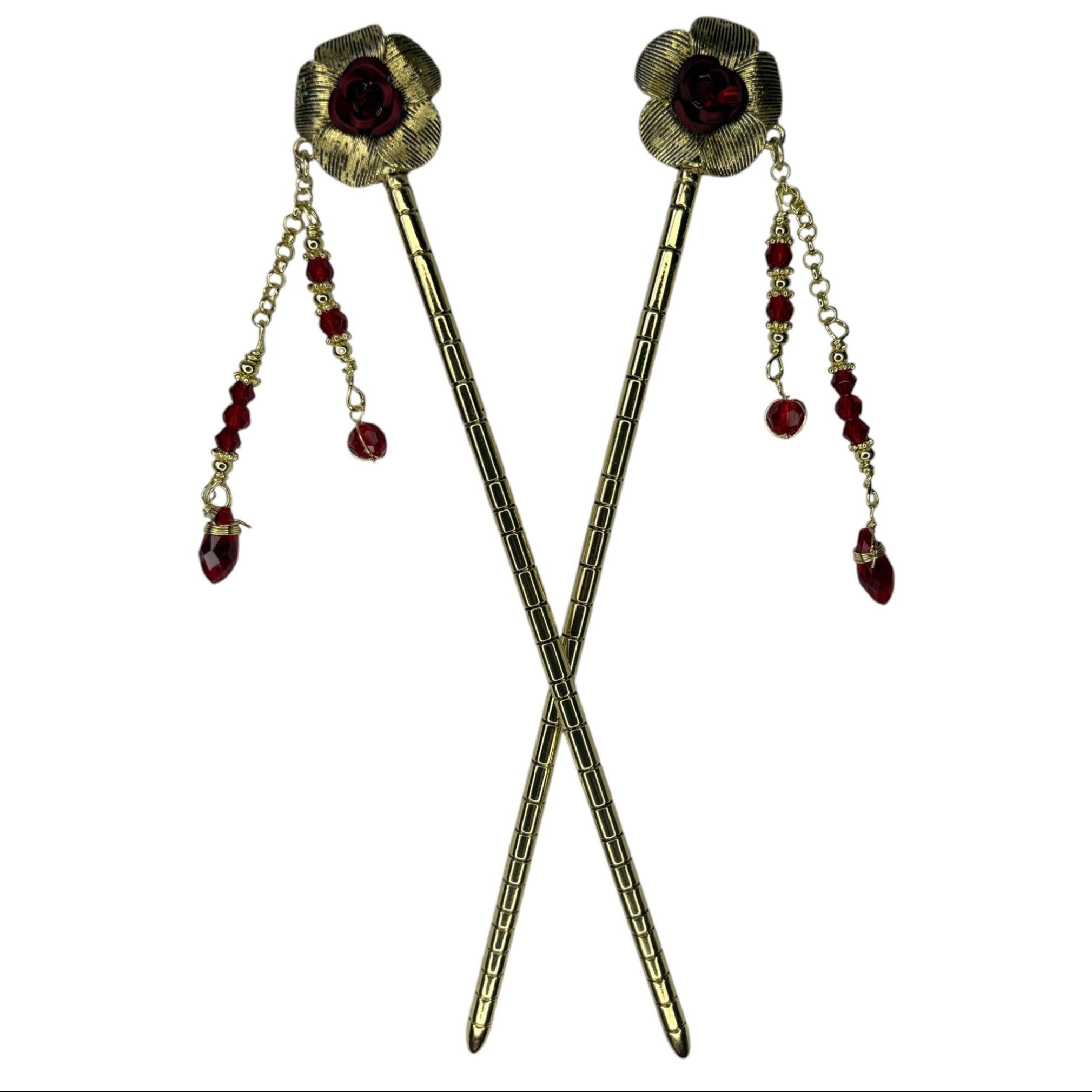 Pair of antique gold flower hair sticks with red rose centers and red crystal bead dangle chains, shown crossed on a white background to display the front view.