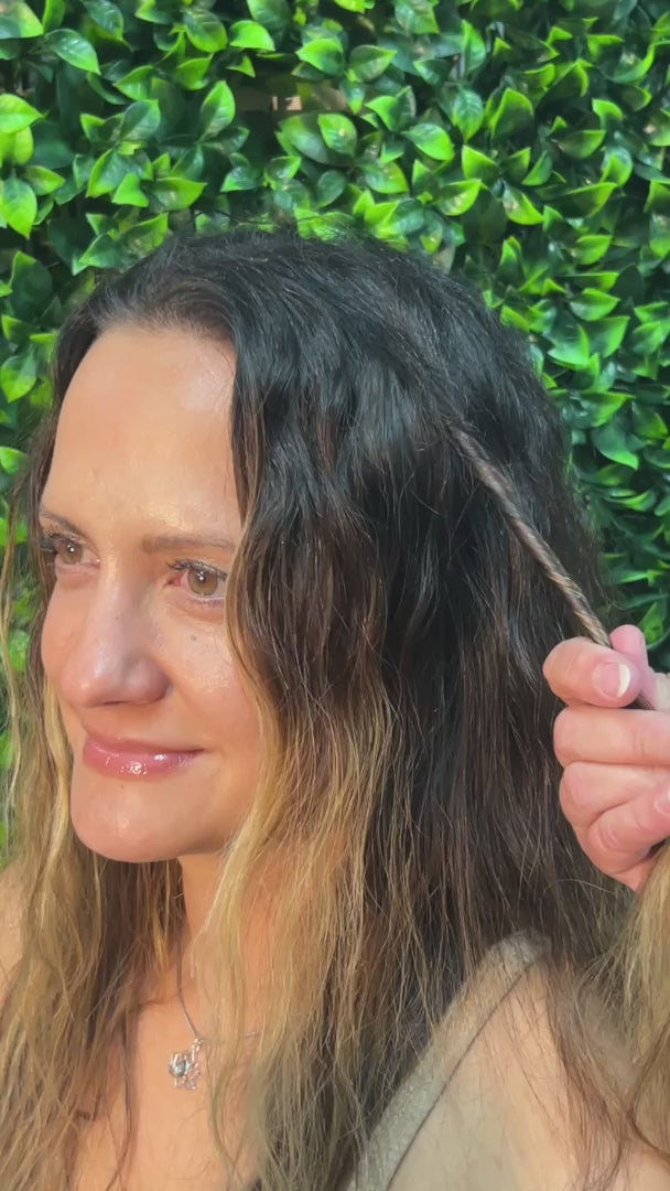 Step-by-step demonstration of a 4-inch gun black Hair Twister being twisted around a section of long blonde hair on a model, illustrating how the spiral hair wrap is installed and worn.