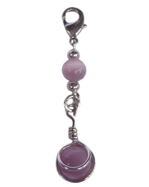 Pink bead hair charm with silver metal wrap and clasp on white background