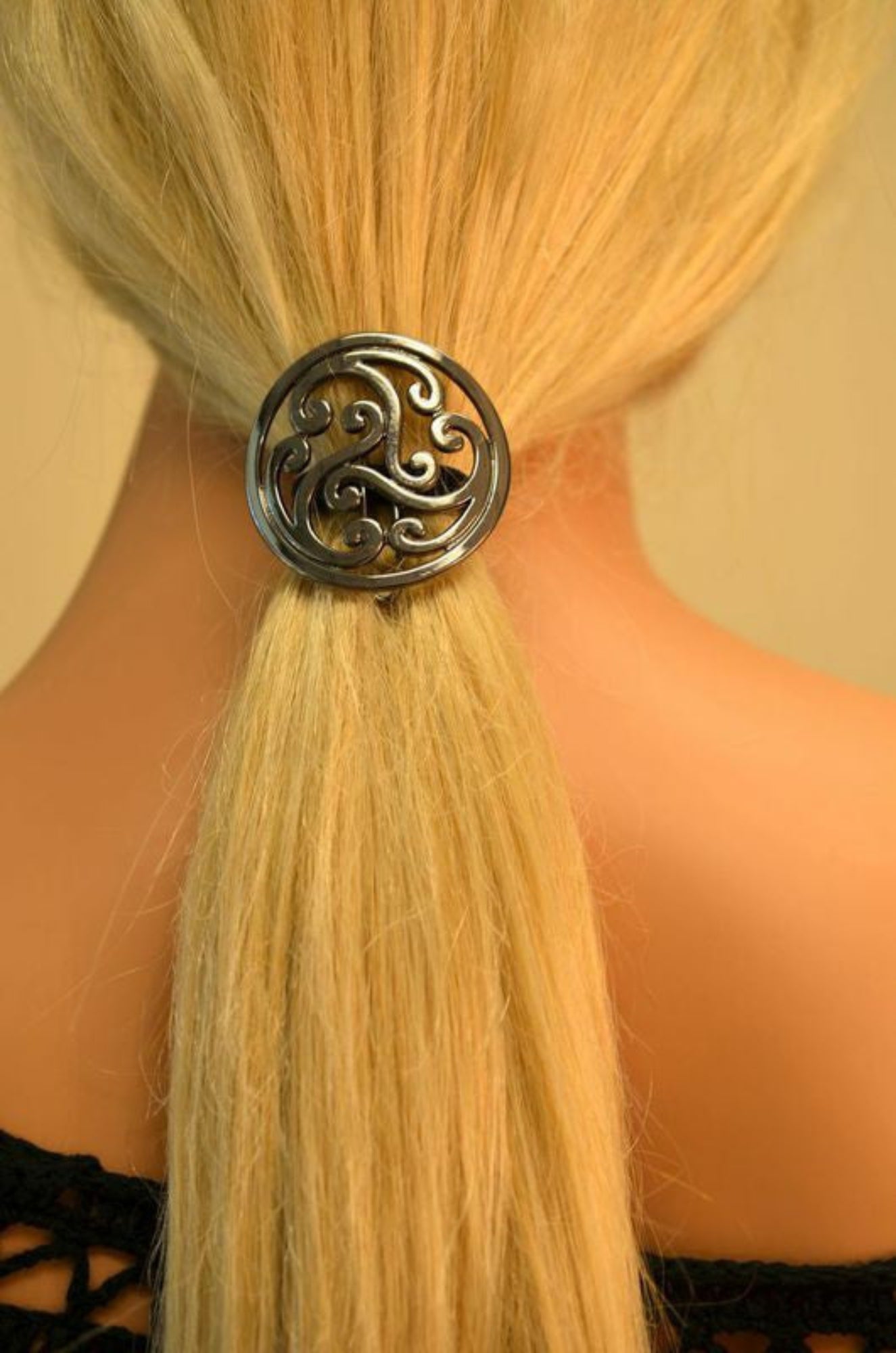 Model wearing gun black Celtic circle hair hook in ponytail