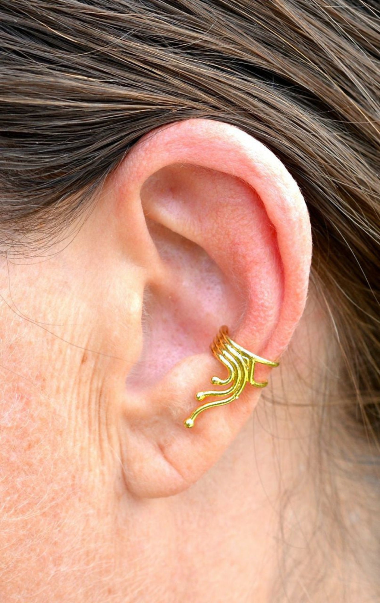 gold spiral wave ear cuff on ear non piercing earring side view