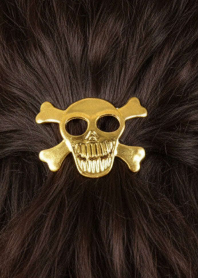 Gold skull and crossbones hair hook securing ponytail, back view