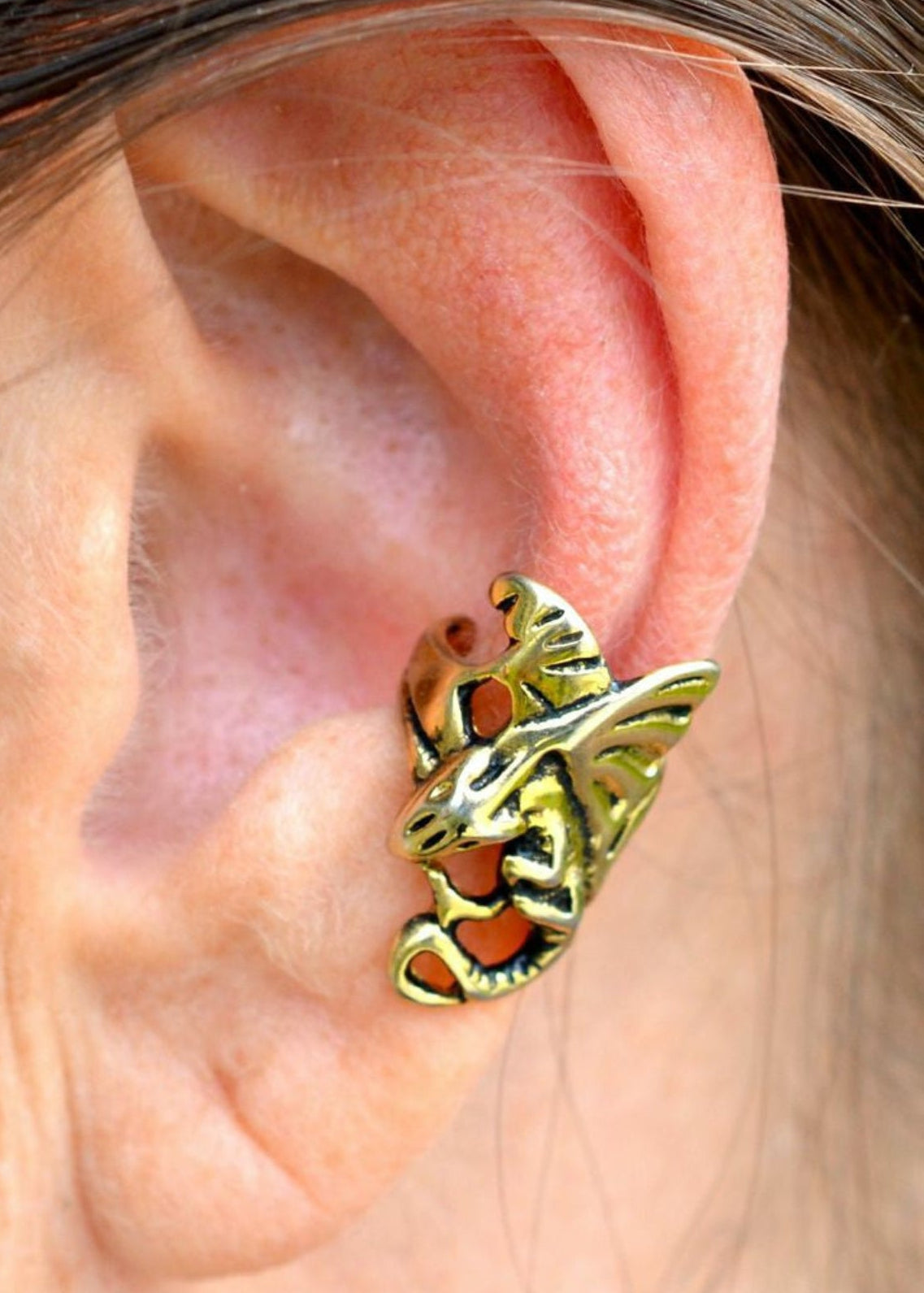 gold dragon ear cuff worn on ear non piercing earring side view