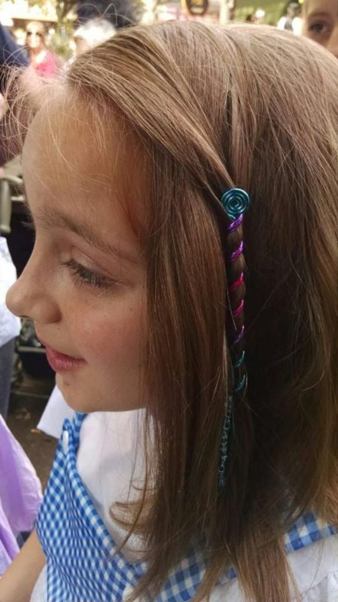 Model wearing Rainbow Hair Twister - 4" Blue Spiral Wrap Ponytail Accessory