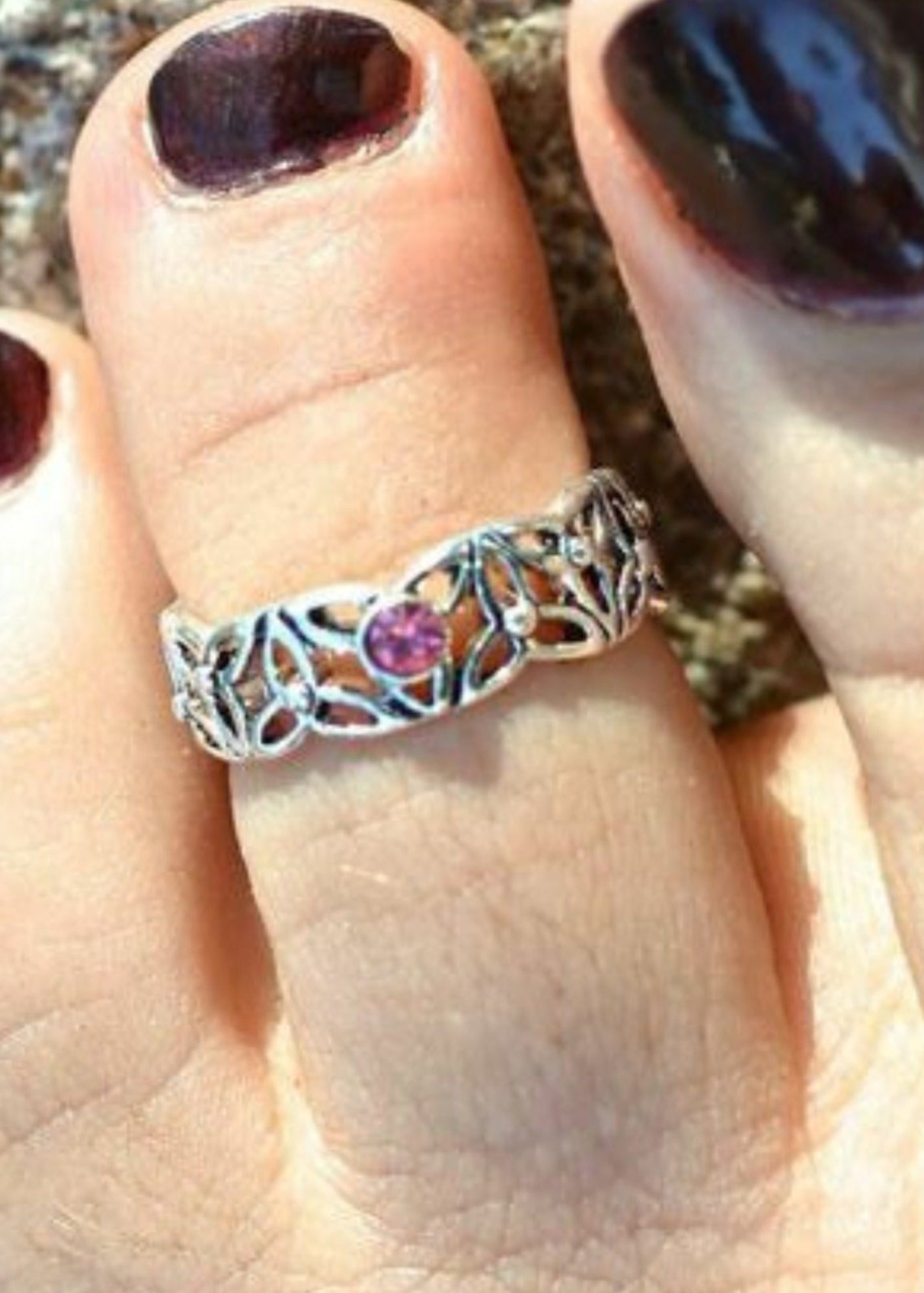 Silver Celtic knot adjustable toe ring with pink gemstone worn on toe