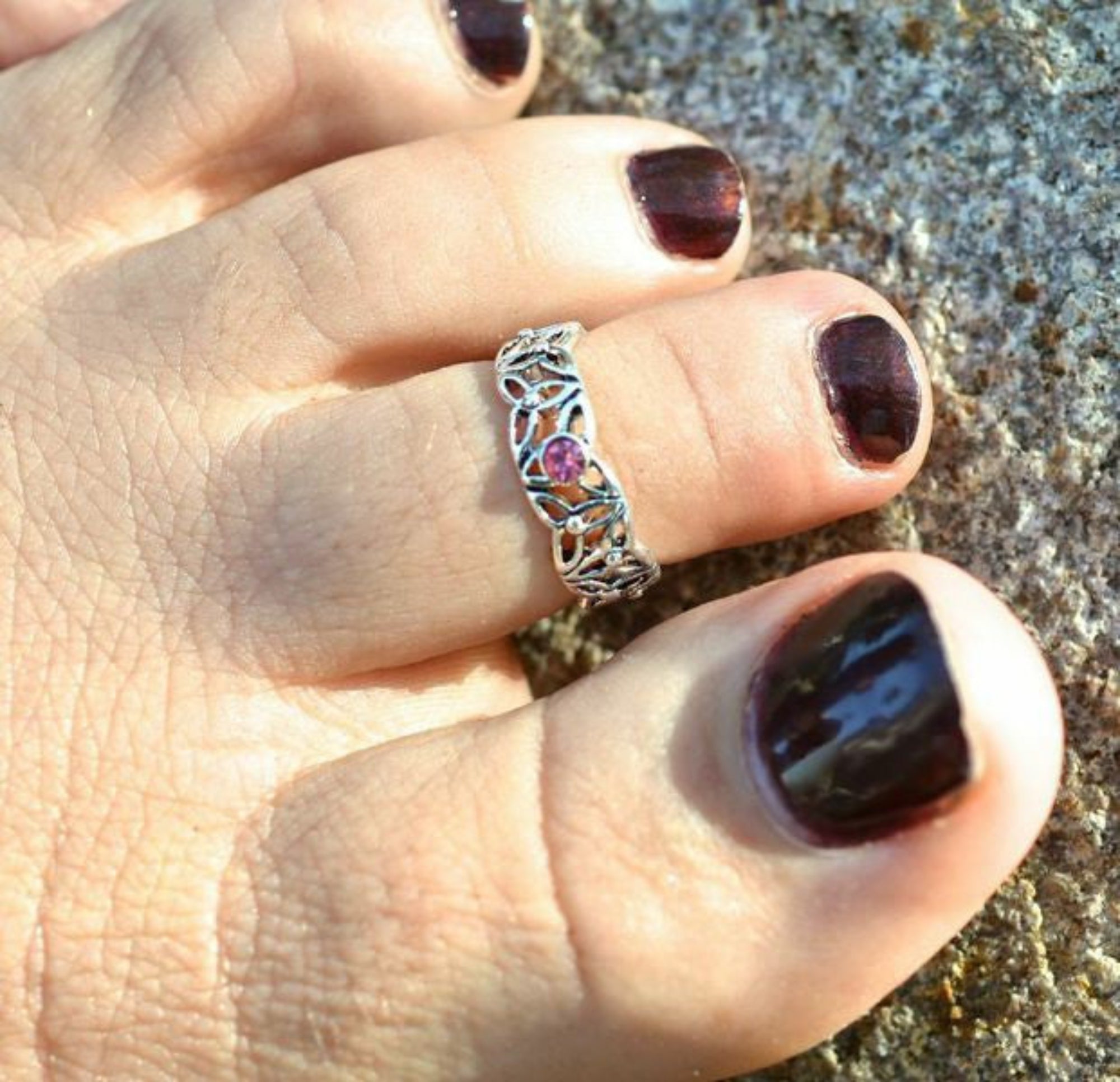Silver Celtic knot adjustable toe ring with pink gemstone worn on toe