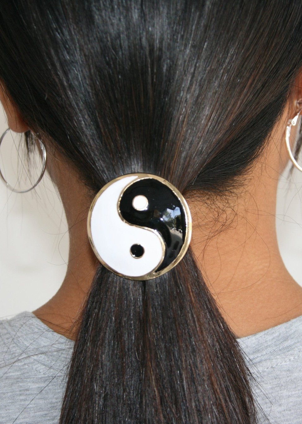Model wearing gold yin yang enamel hair hook ponytail holder, back view in hair