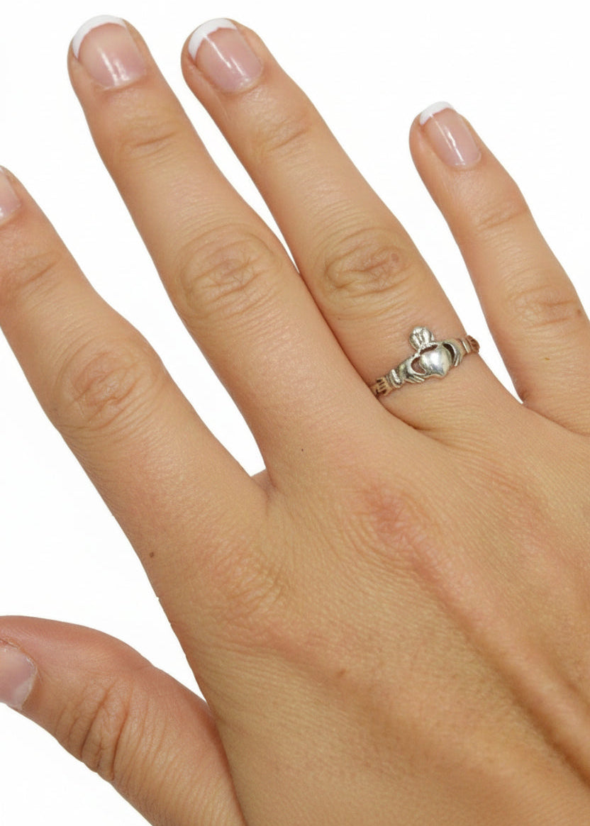 Model wearing sterling silver claddagh thin band ring