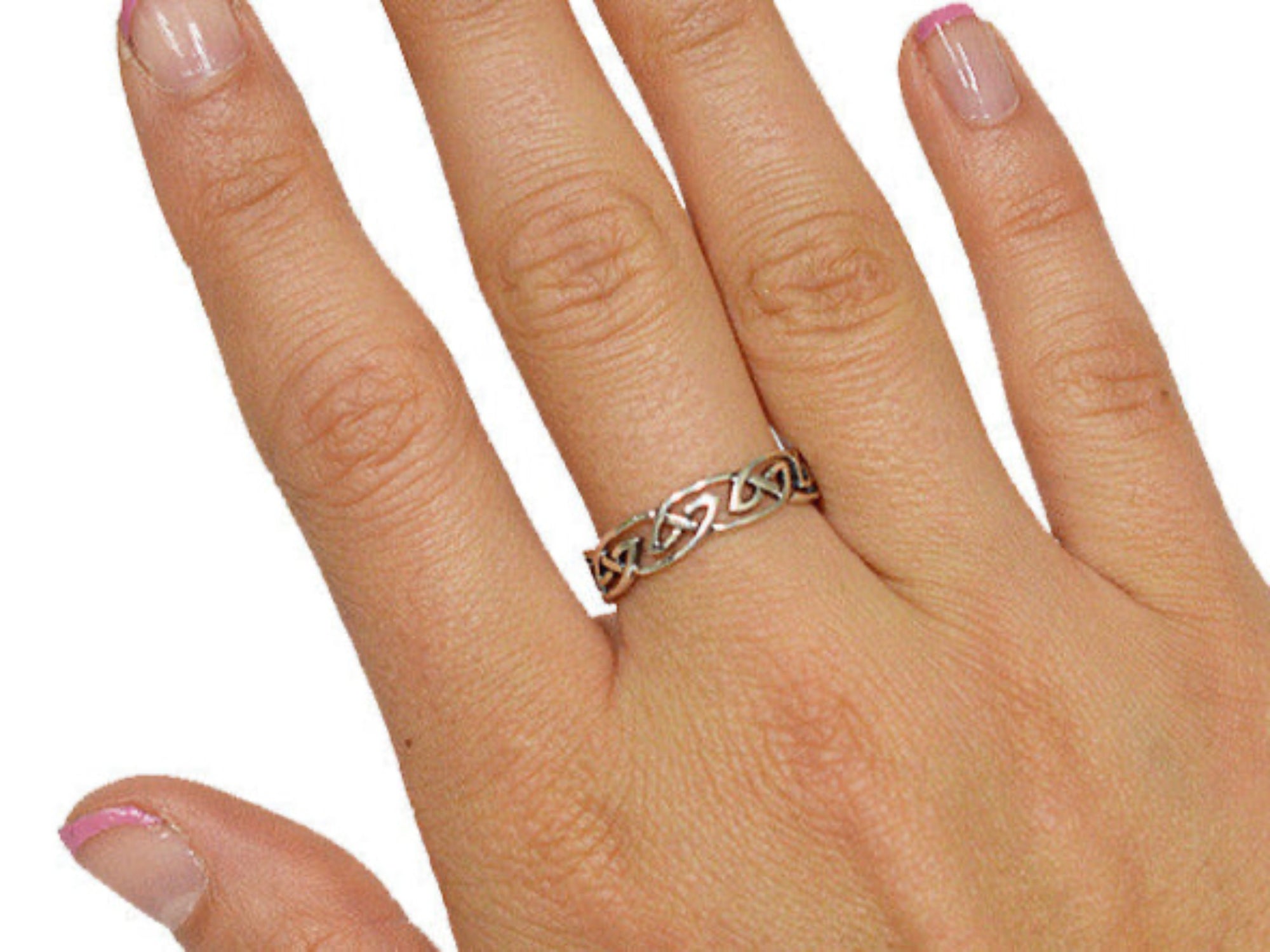 Model wearing Celtic barbed wire ring in sterling silver with interwoven knot design