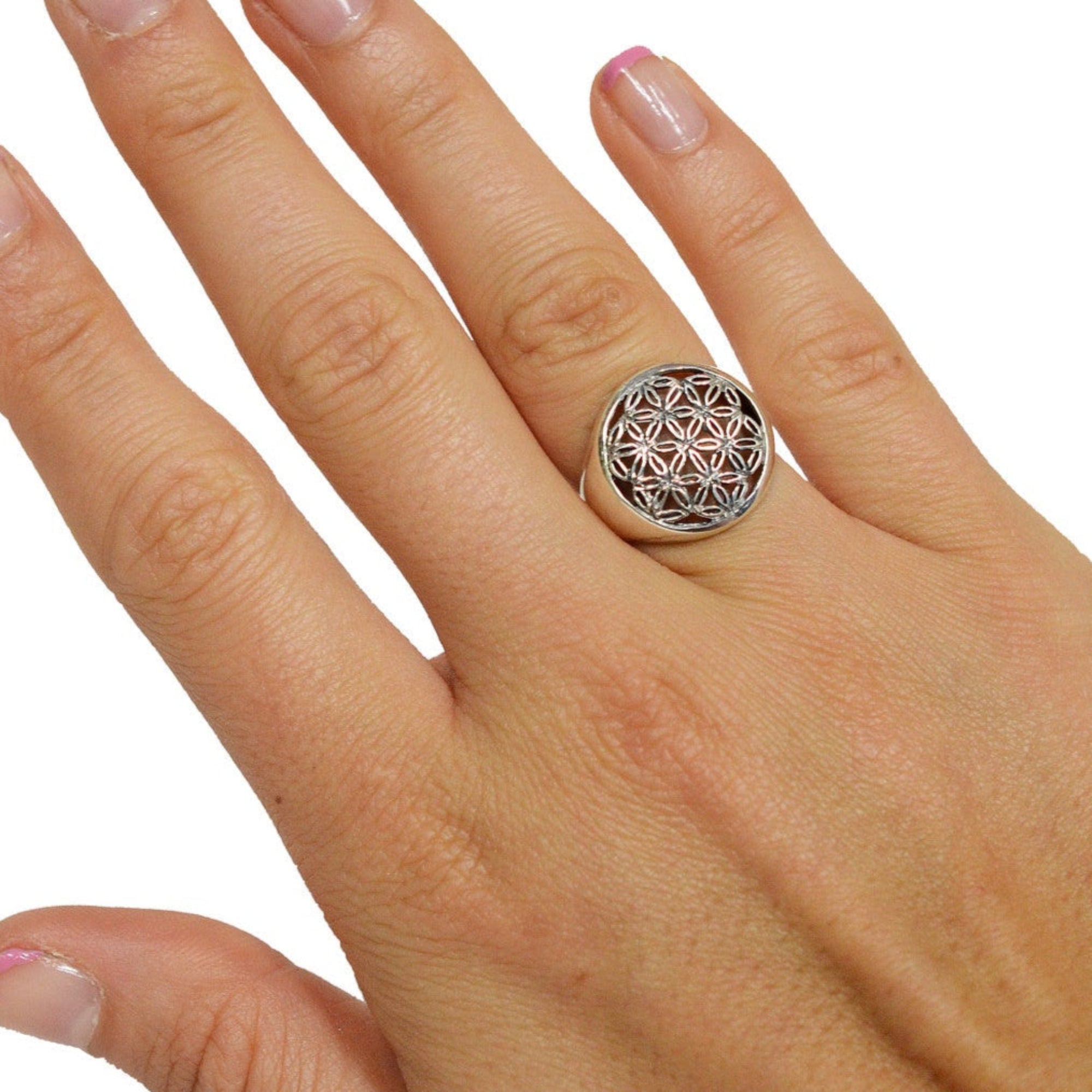 Model wearing Flower of Life ring in sterling silver with sacred geometry design, front view on hand
