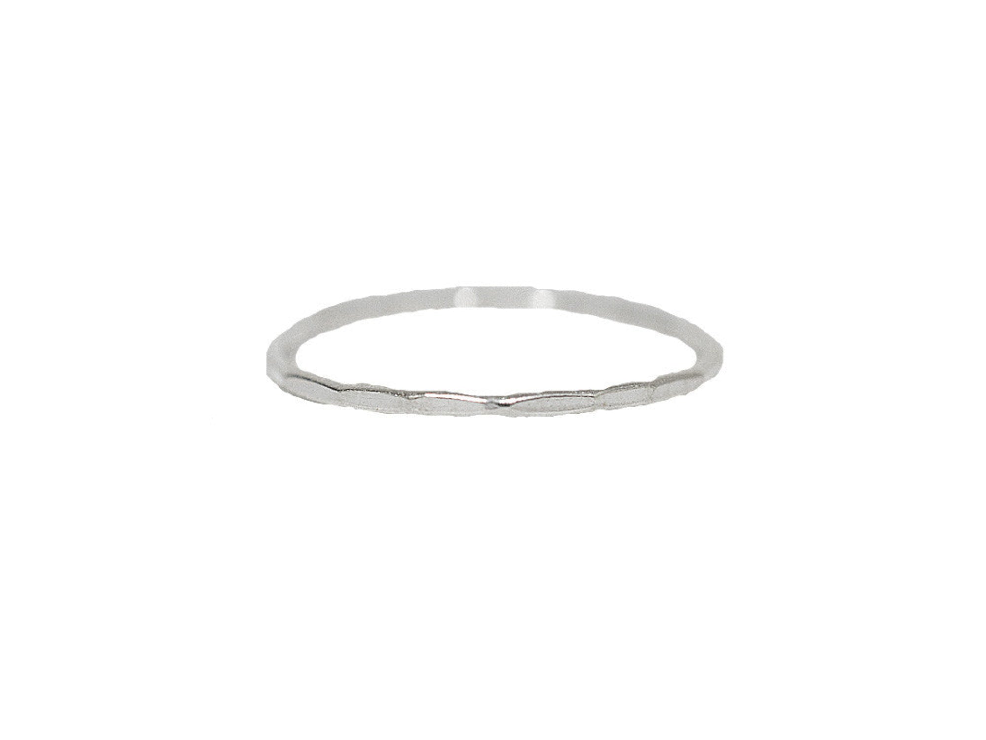 Hammered thin band ring in sterling silver with subtle textured finish, isolated on white background