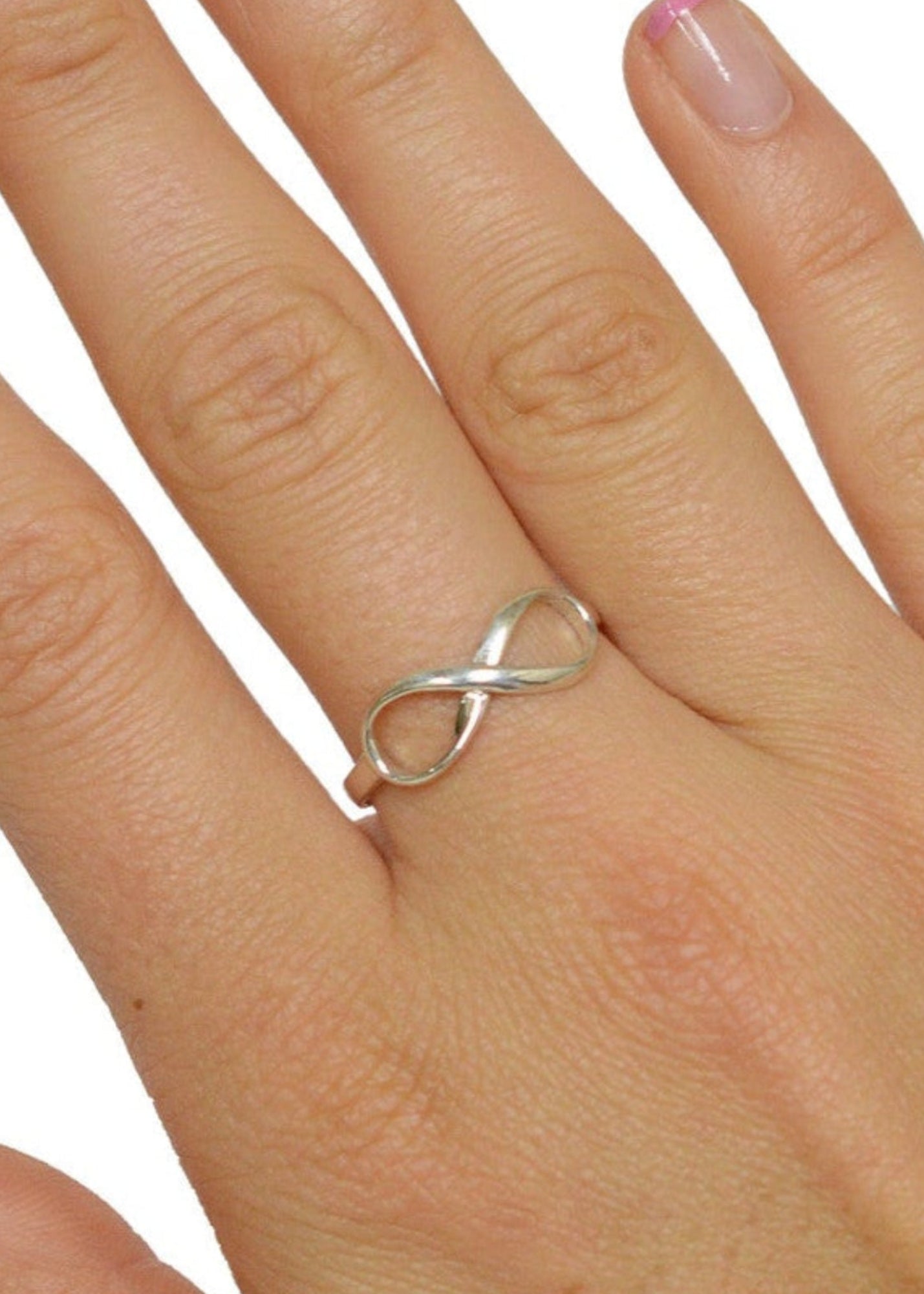 Model wearing infinity ring in sterling silver with infinity symbol design, minimalist ring on hand, front view