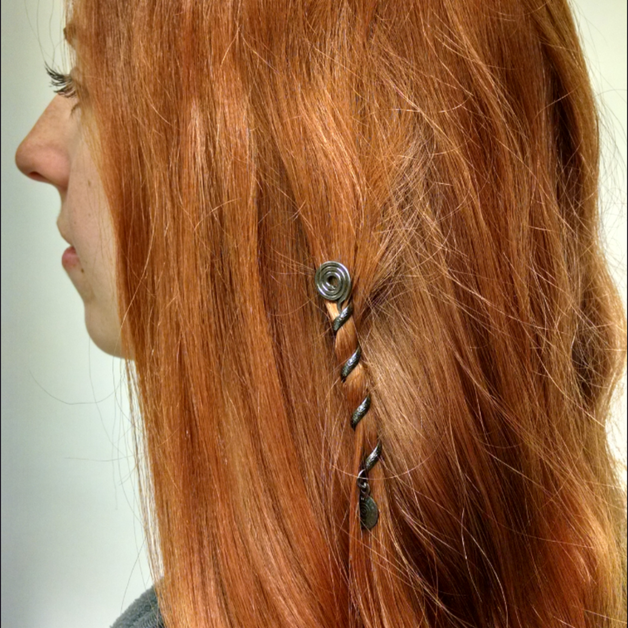2 inch gun black spiral hair twister worn in long hair, side view
