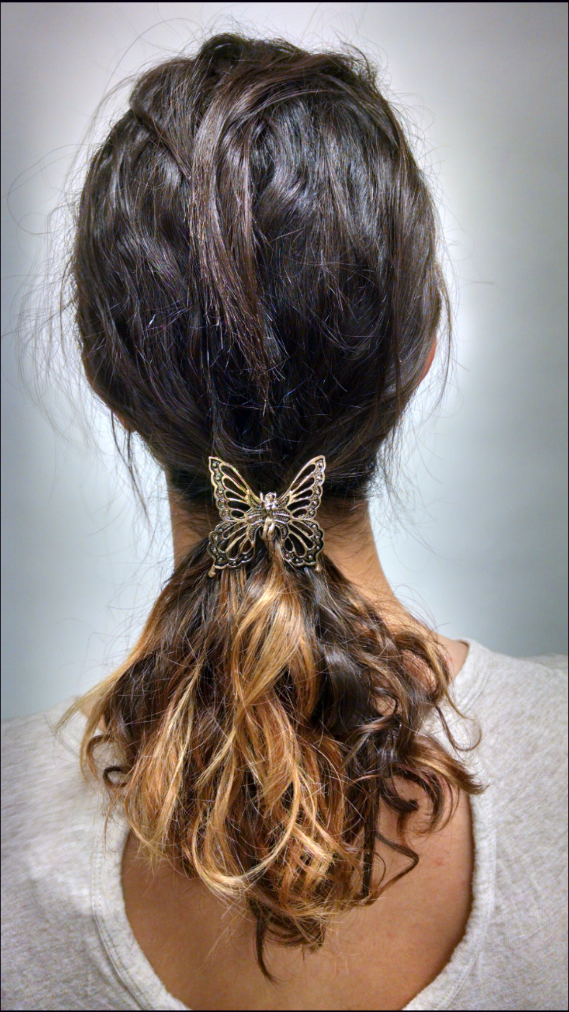 Gold fairy butterfly ponytail hair hook securing ponytail, back view