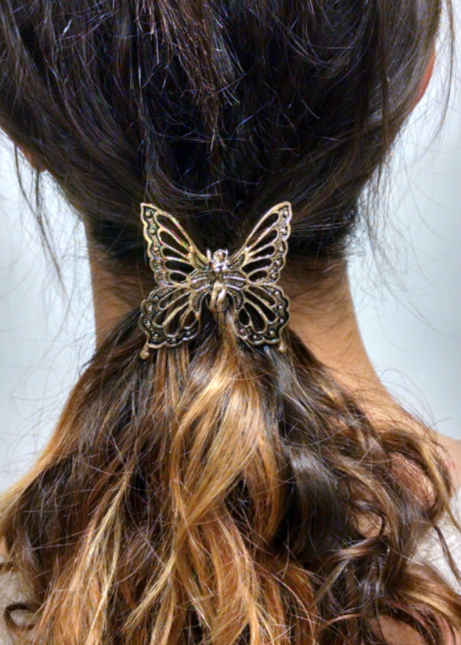 Gold fairy butterfly ponytail hair hook securing ponytail, back view