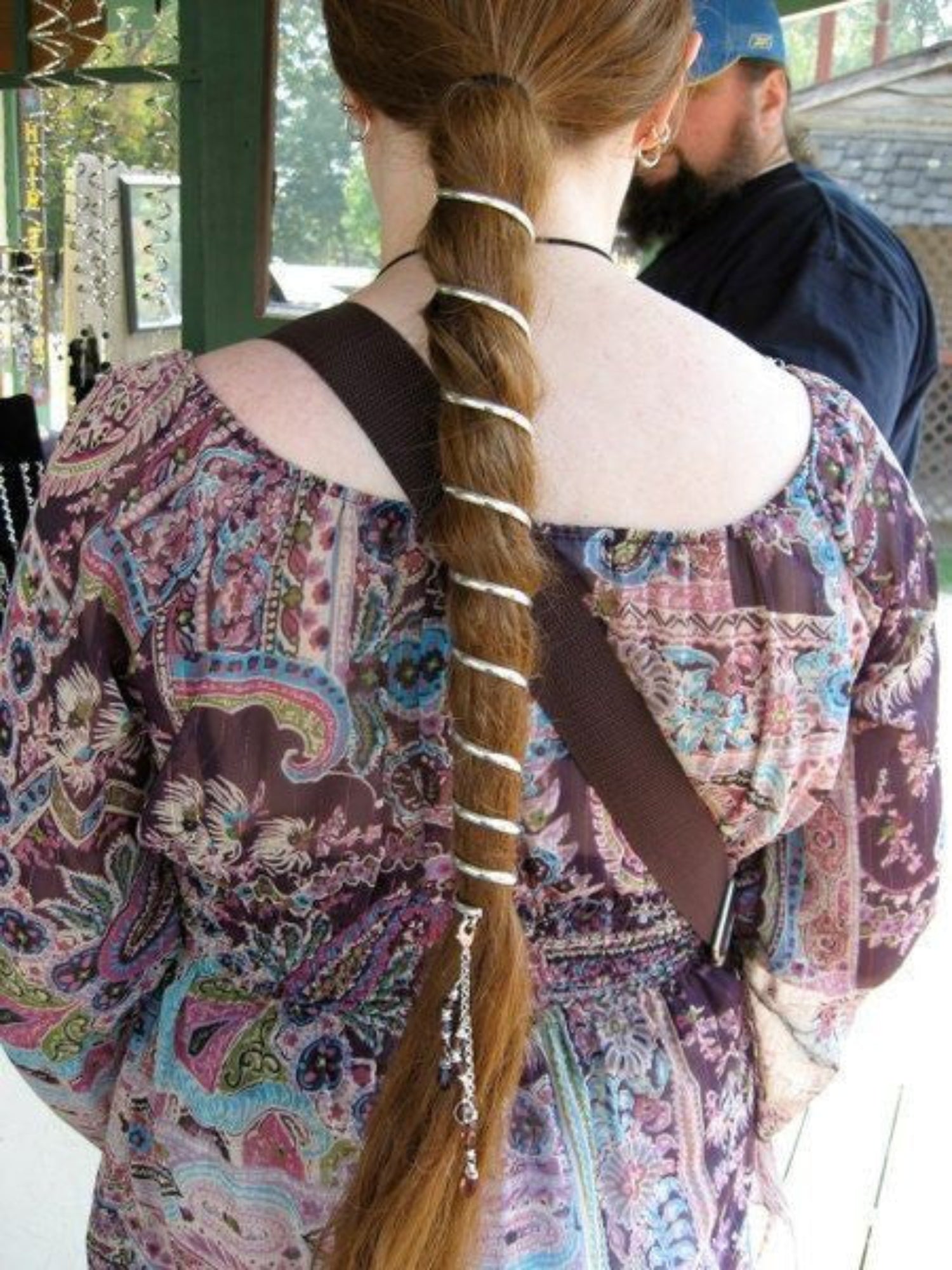 Model wearing 12-inch silver ponytail wrap hair accessory in festival setting