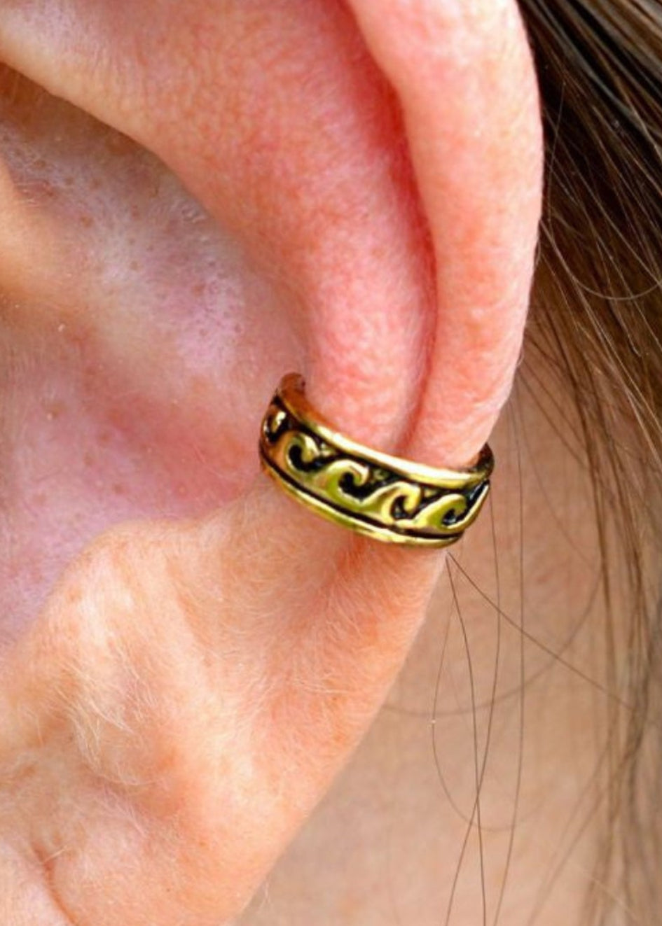 gold ear cuff with black wave pattern non piercing adjustable earring front view