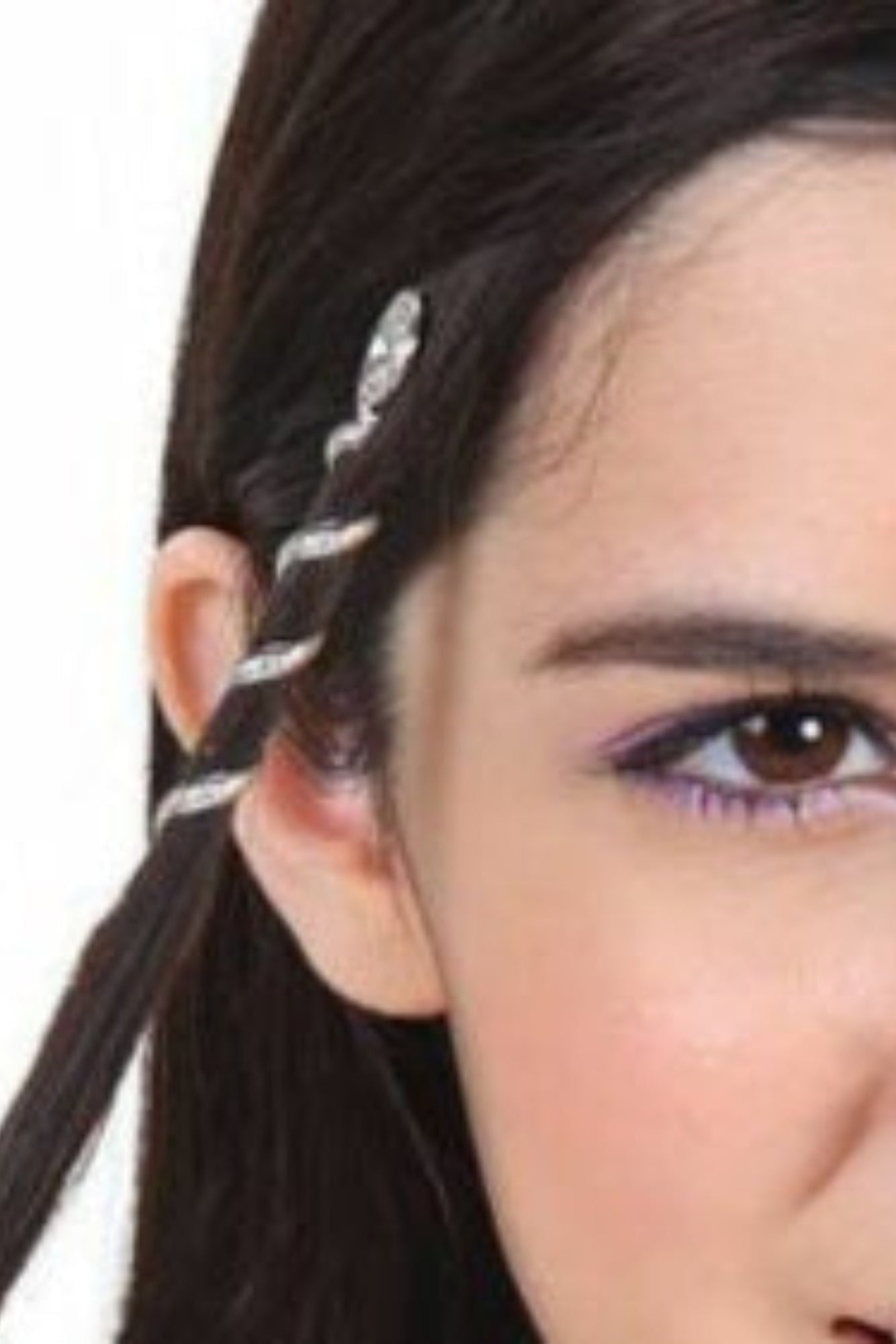 Model wearing a 2-inch silver Spiral Hair Twister securing a small side ponytail near the ear.