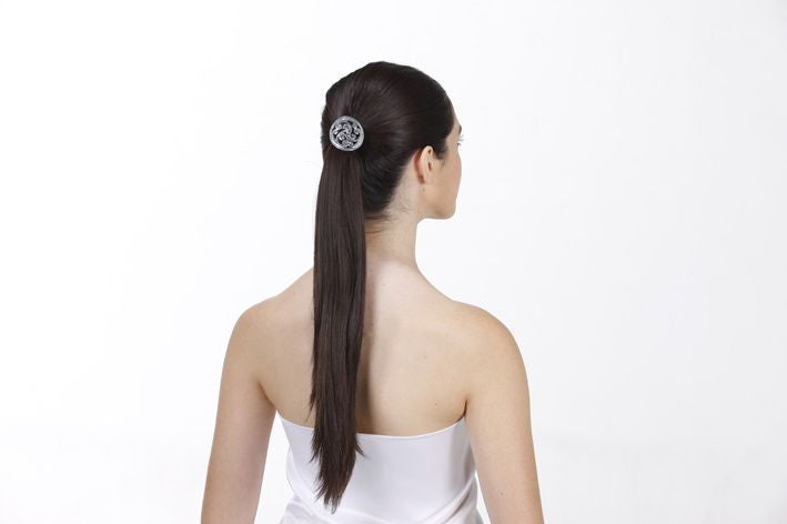 Model wearing Silver Celtic Hair Hook ponytail holder at rave, festival hair accessory.